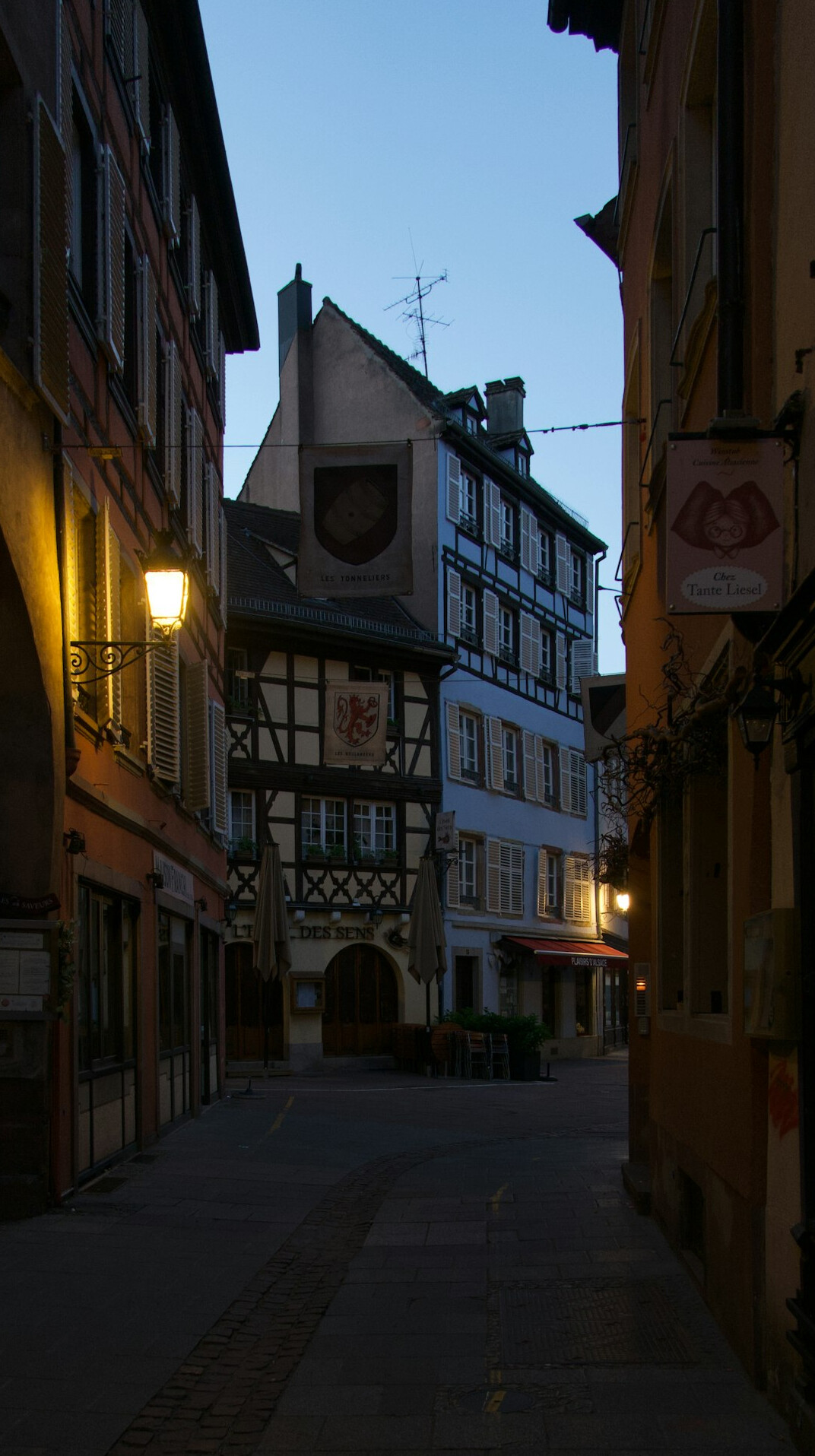 Old city street at dusk with warm street lights